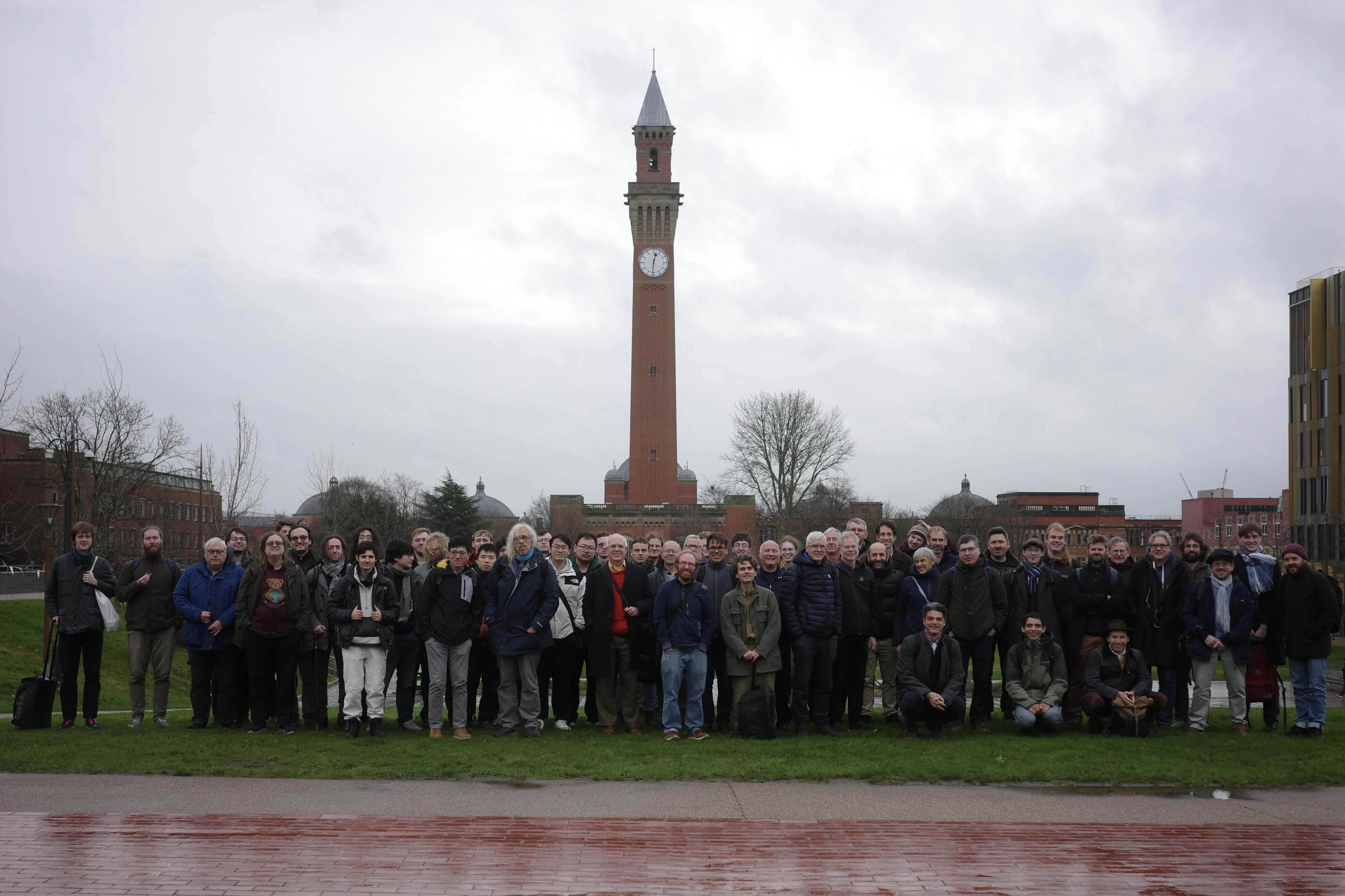Group photo, taken outside in rainy conditions on 17 December 2025 with Old Joe in the background